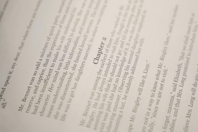 Close-up of an open book showing text and chapter 2 heading, ideal for literature themes.